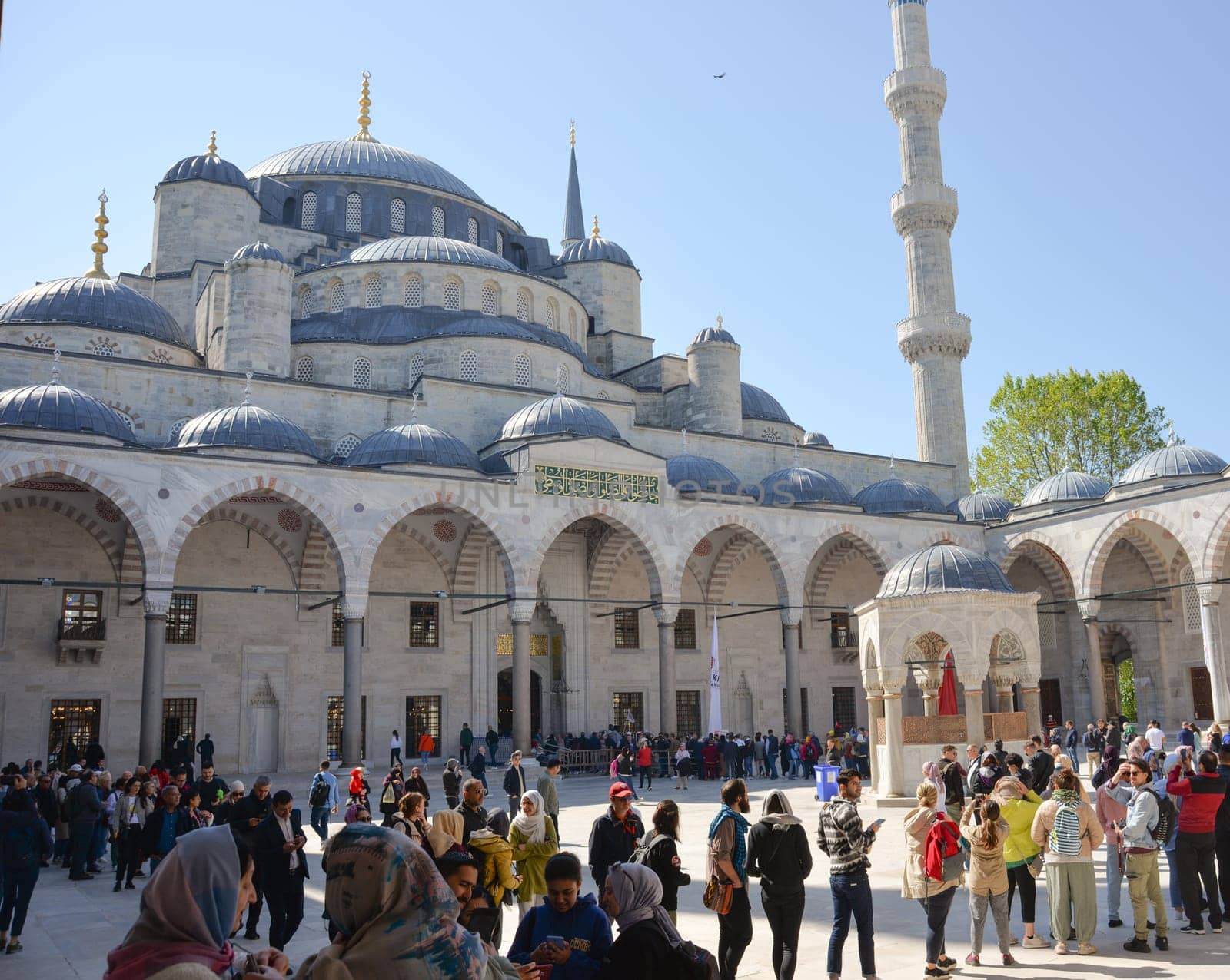 Istanbul, Turkey, May 02, 2023: Tourists admire the Blue Mosque,Sultan Ahmet Mosque. Architectural element of Muslim architecture by Ekaterina34