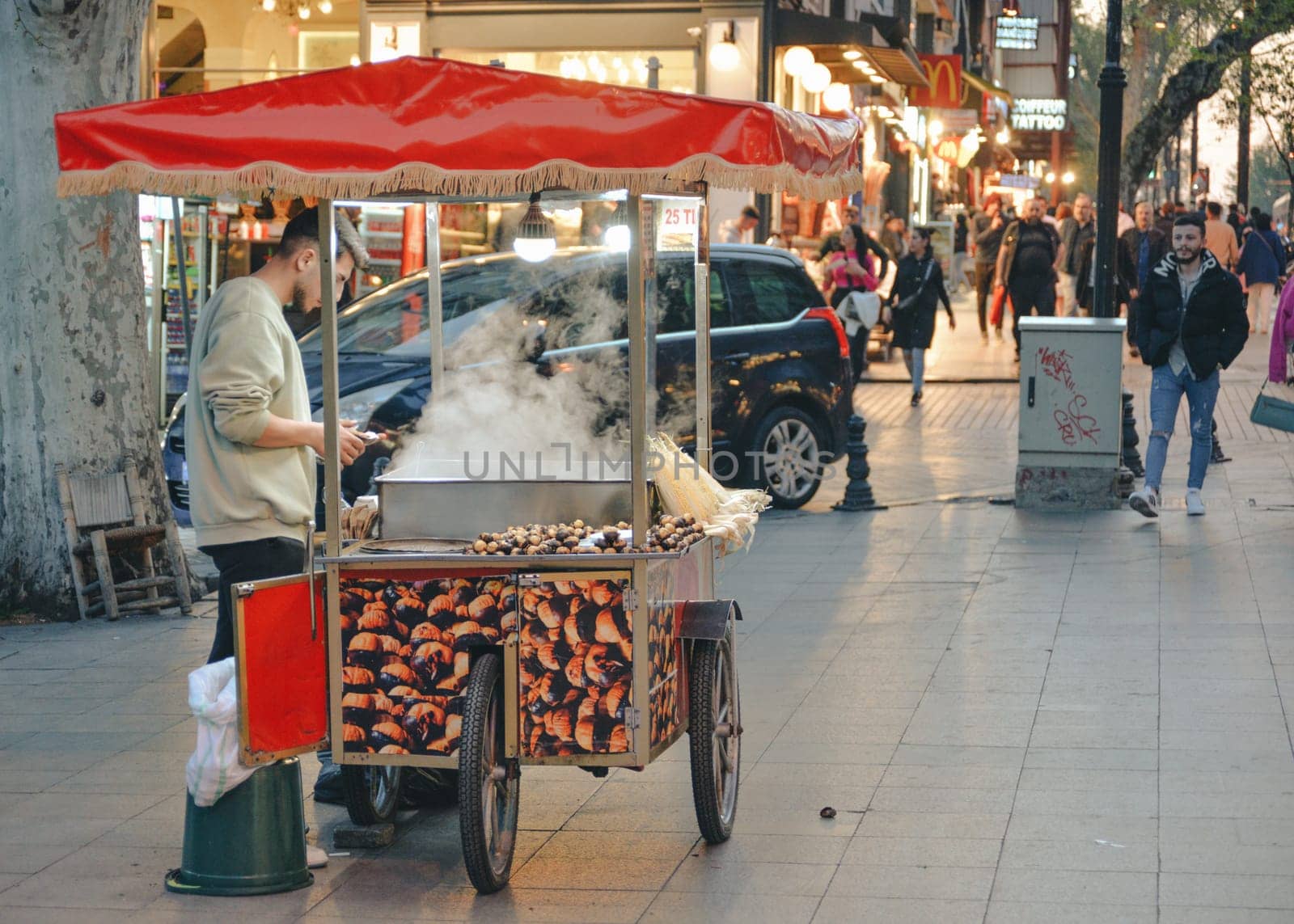 Istanbul, Turkey - May 02, 2023: Seller of roasted chestnuts and corn on the street in Istanbul. by Ekaterina34