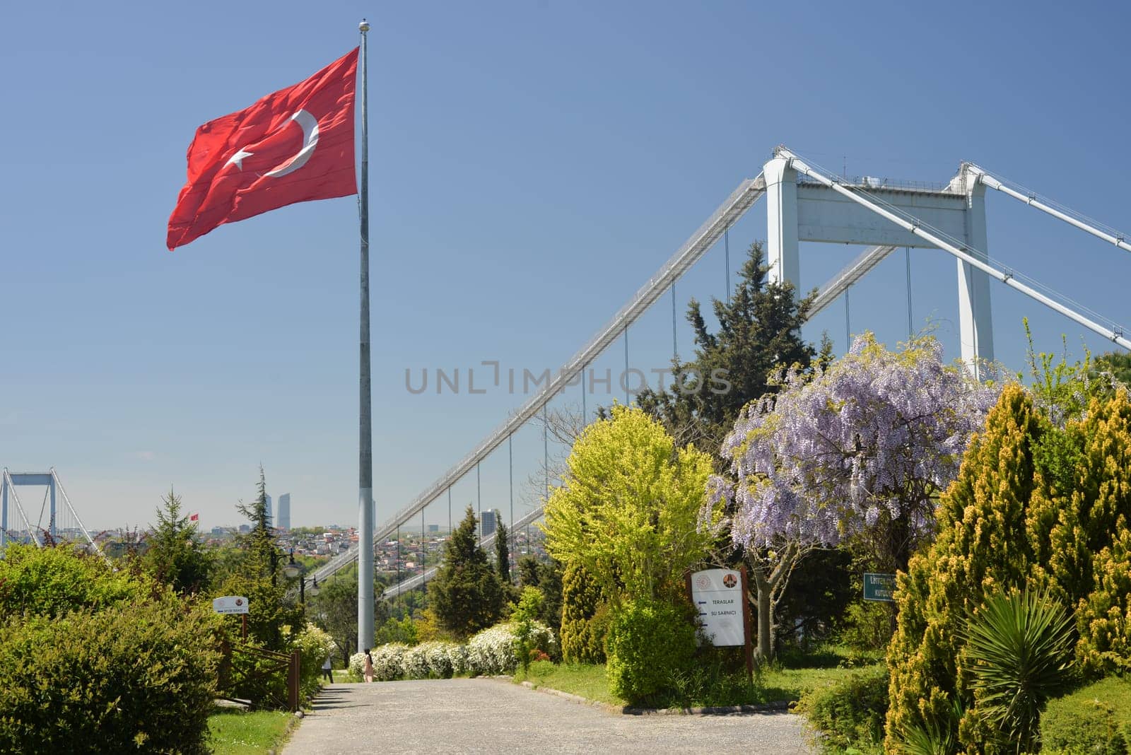 Istanbul, Turkey, May 02, 2023: View of Istanbul from Otagtepe with the Fatih Sultan Mehmet Bridge and flag waving in the wind. Travel Istanbul background photo