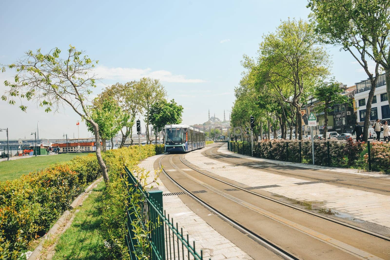 Istanbul, Turkey, May 02, 2023: View of a moving tram against the background of a mosque in Istanbul, Istanbul public transport with tourists.