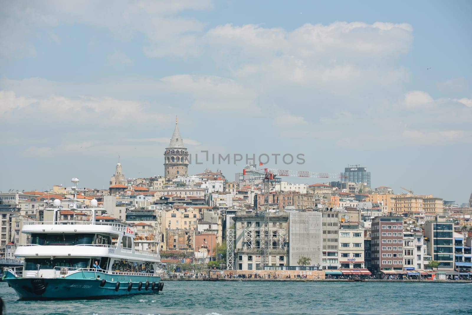 Istanbul, Turkey - May 02, 2023: Traveling along the Bosphorus on the passenger ferry. View of the Galata bridge, Galata tower by Ekaterina34