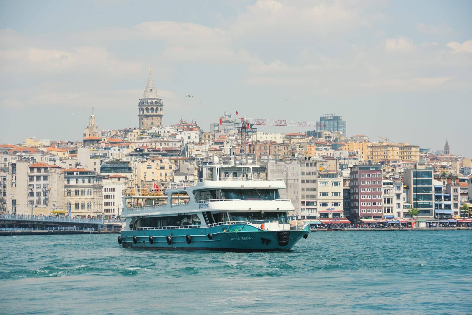 Istanbul, Turkey - May 02, 2023: Traveling along the Bosphorus on the passenger ferry Eminönü. View of the Galata bridge, Galata tower by Ekaterina34