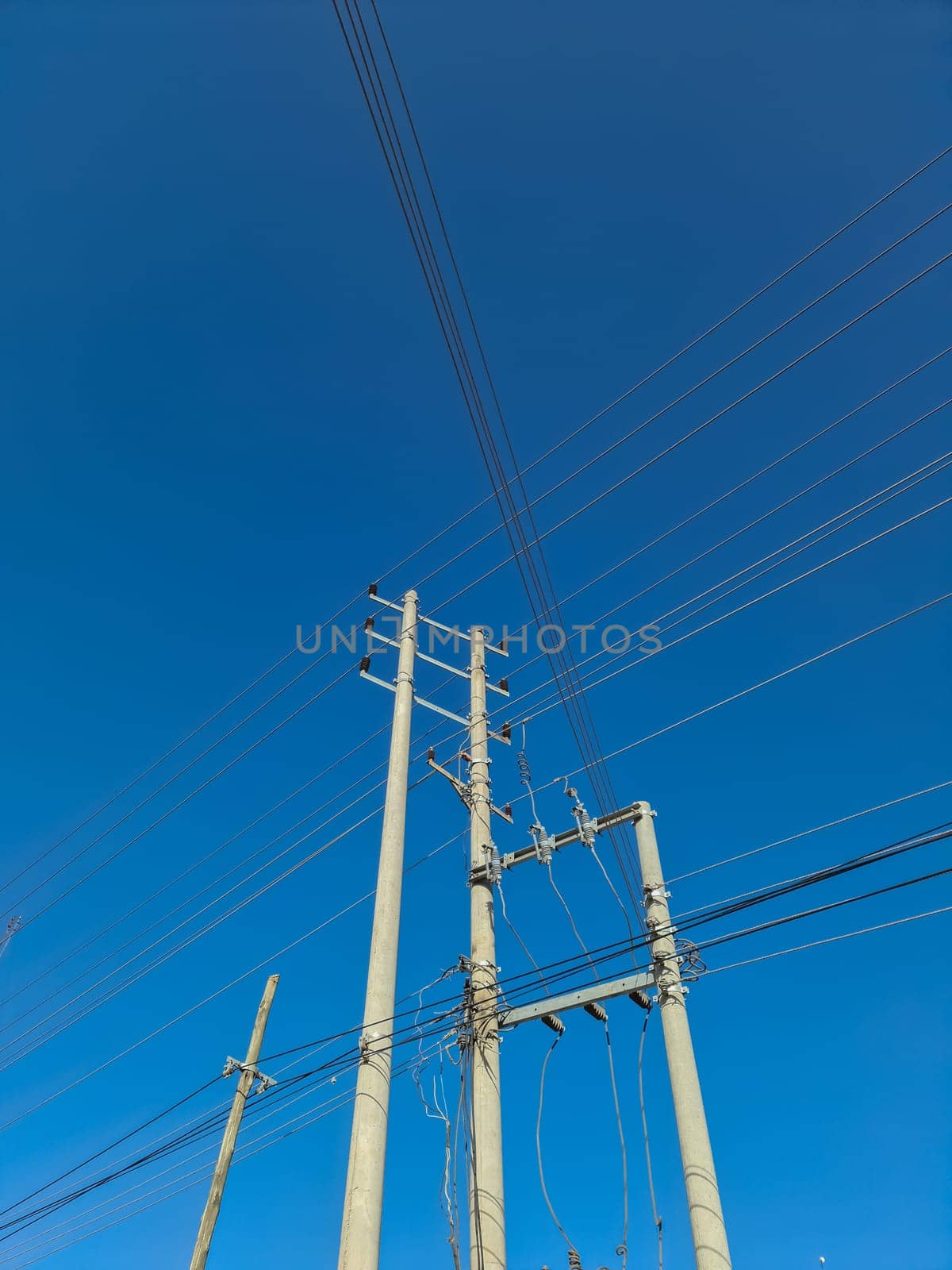 Wildly attached power cables to a power pole