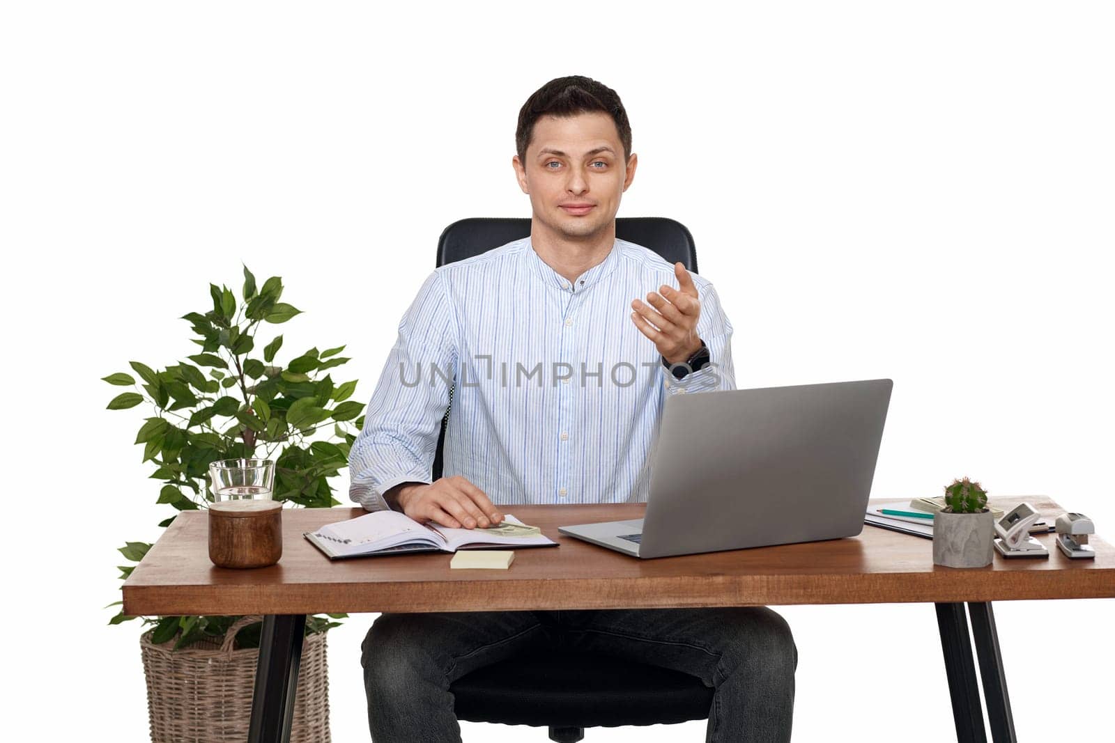 smiling businessman using laptop computer for online work at table on white background