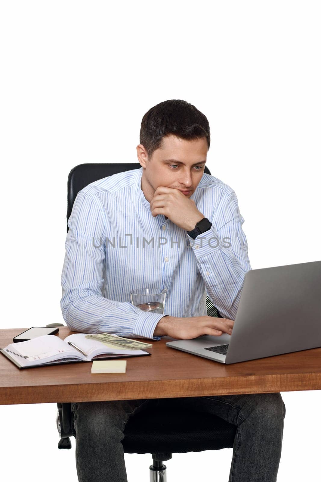 sad businessman using laptop computer for online work at table on white background