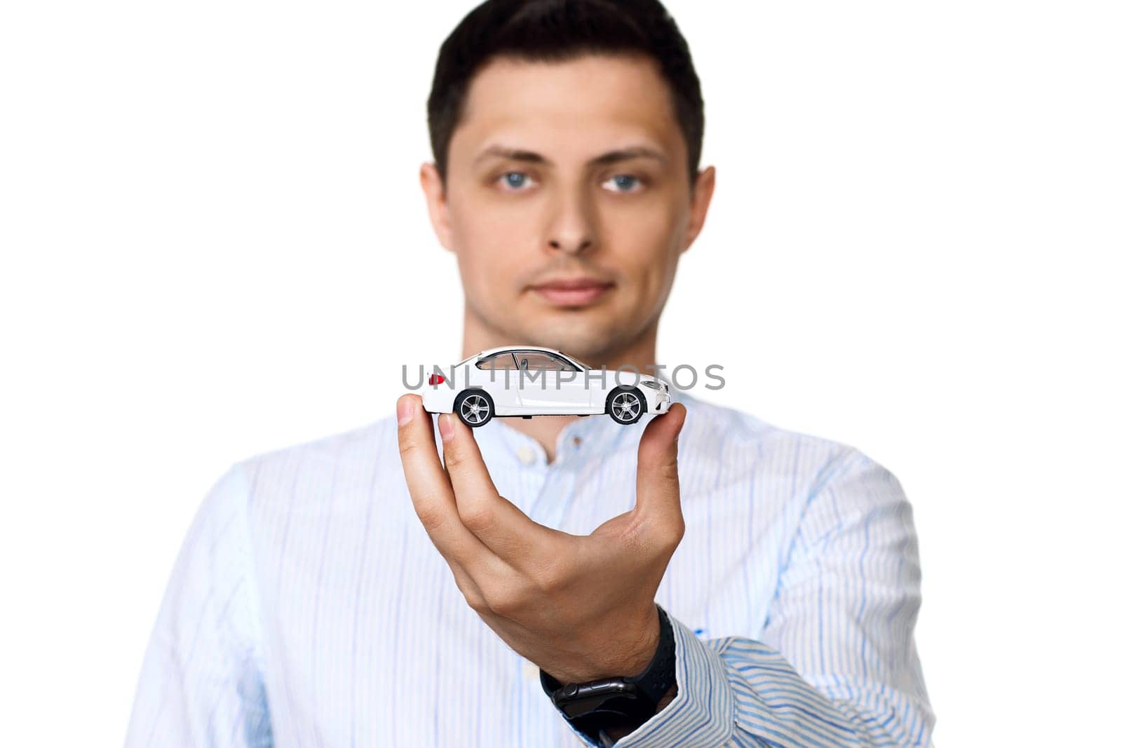 close-up, businessman holding a toy car . Car dealerships offer car . insurance. focus on car