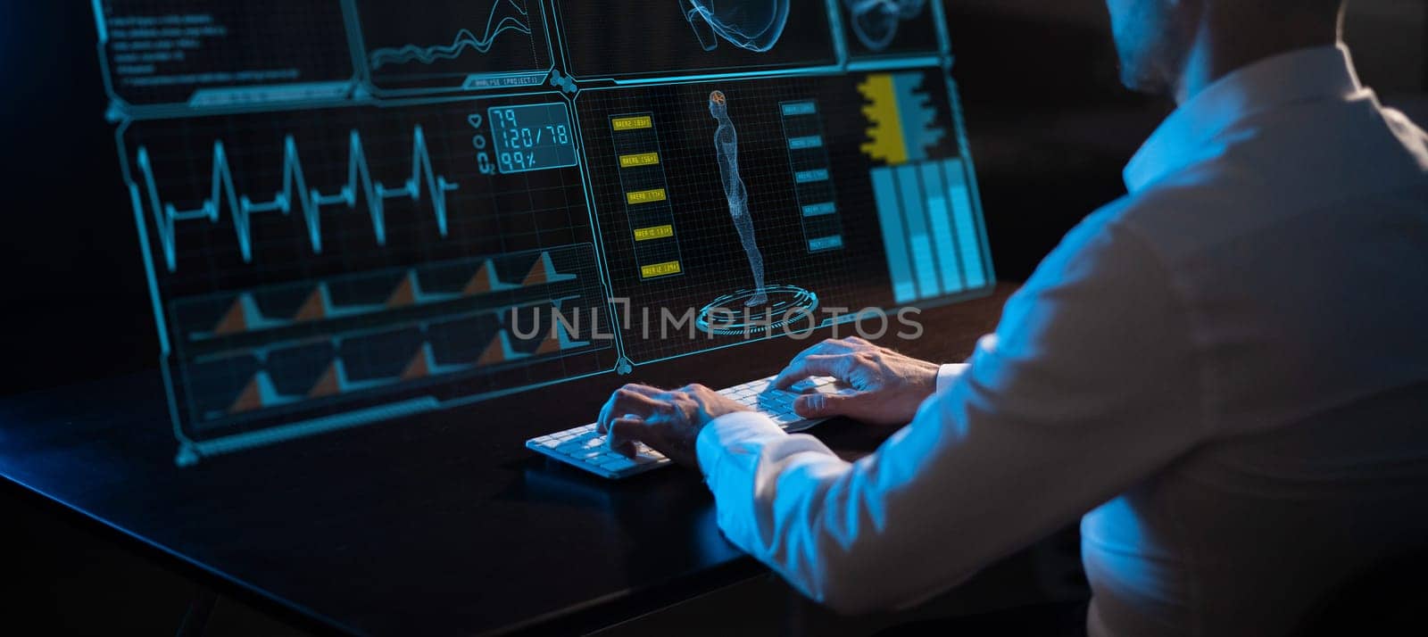 Caucasian man sits in the dark in front of a virtual menu. Close-up of male hands on the keyboard