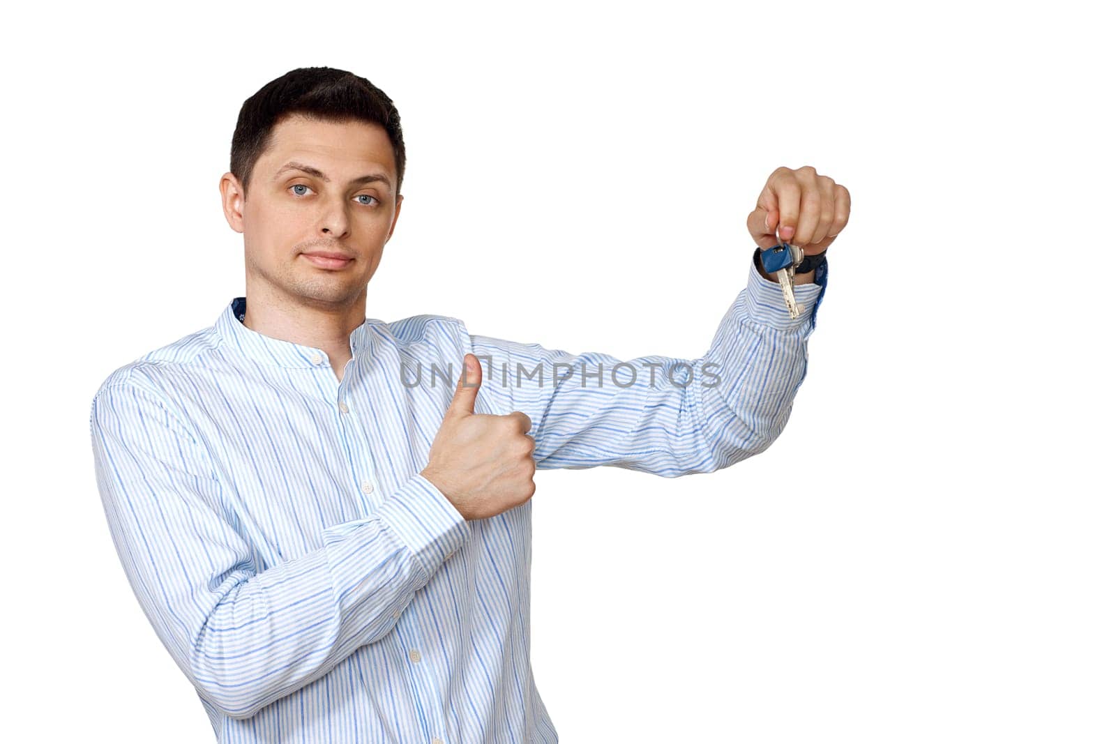 happy caucasian man holding keys on white background.
