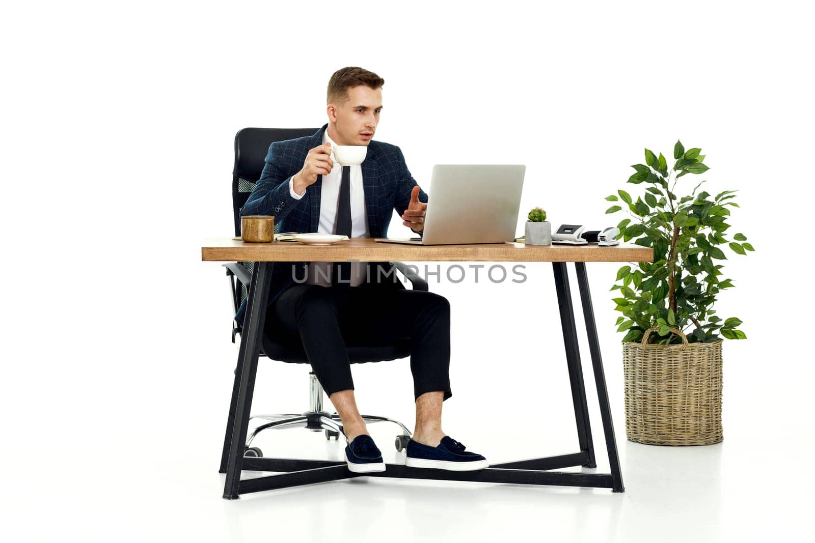 young friendly Freelancer man talking on video call to client, sitting on chair at desk, using laptop pc computer