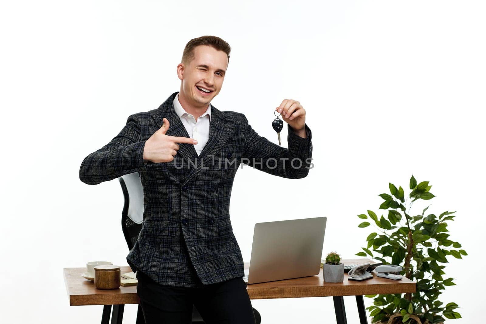 Successful caucasian businessman holding keys in the office. Car dealerships offer car . Car insurance. copy space