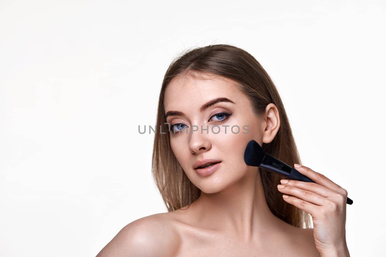 lovely woman posing with make-up brush for powder isolated on white background. copy space