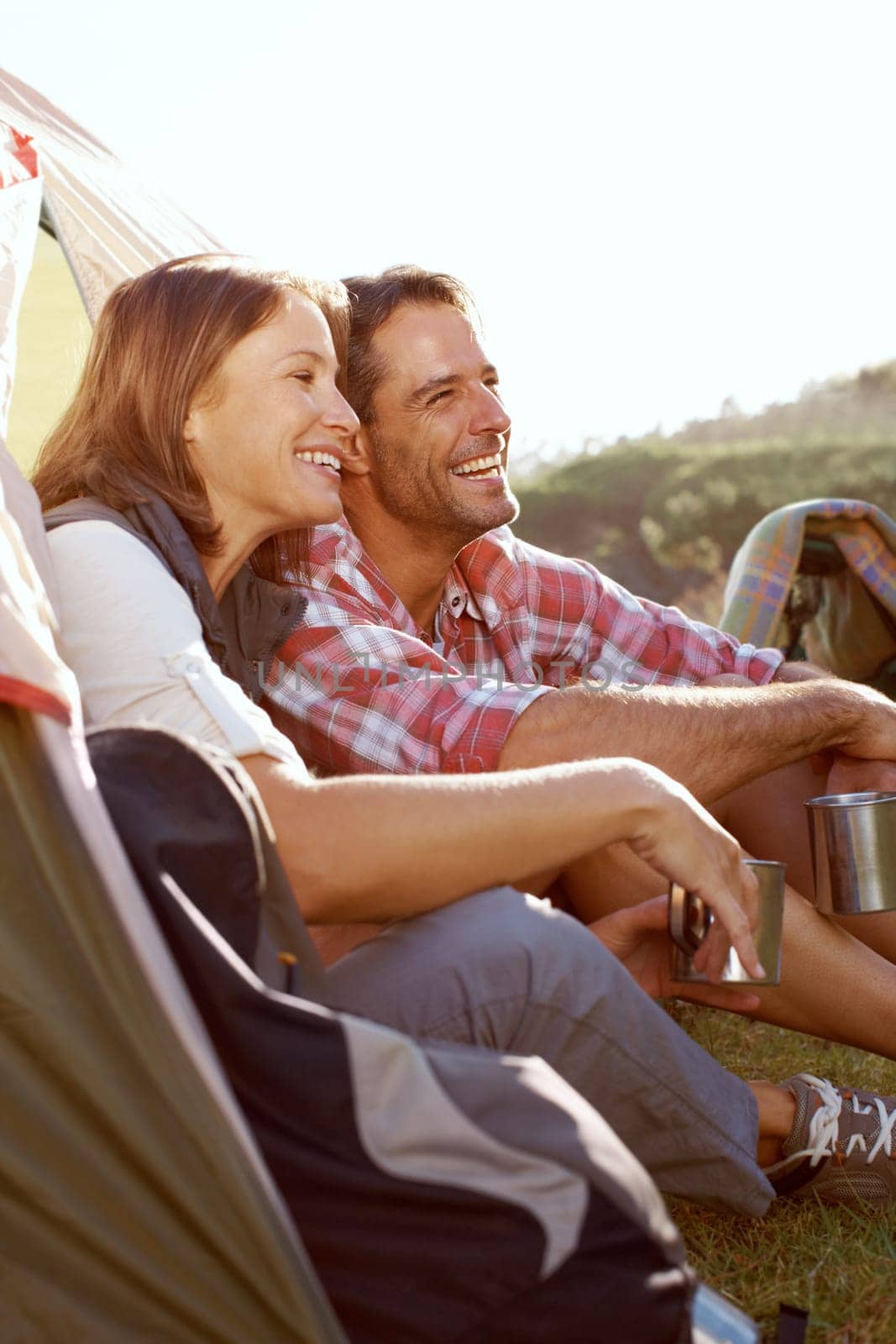 They feel so free in the wild. A young couple enjoying the outdoors while on a camping trip