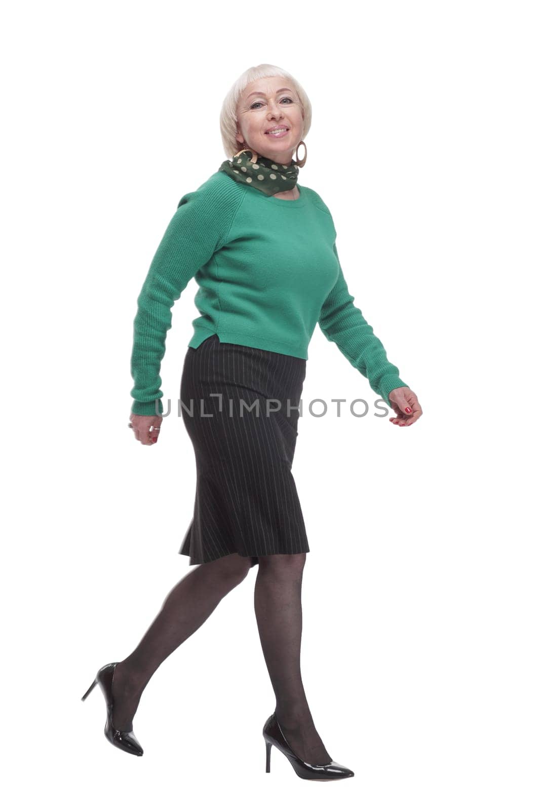 in full growth. woman in a green jumper striding forward. isolated on a white background