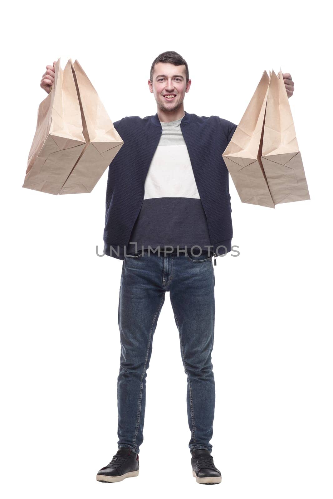smiling young man with shopping bags . isolated on a white background.