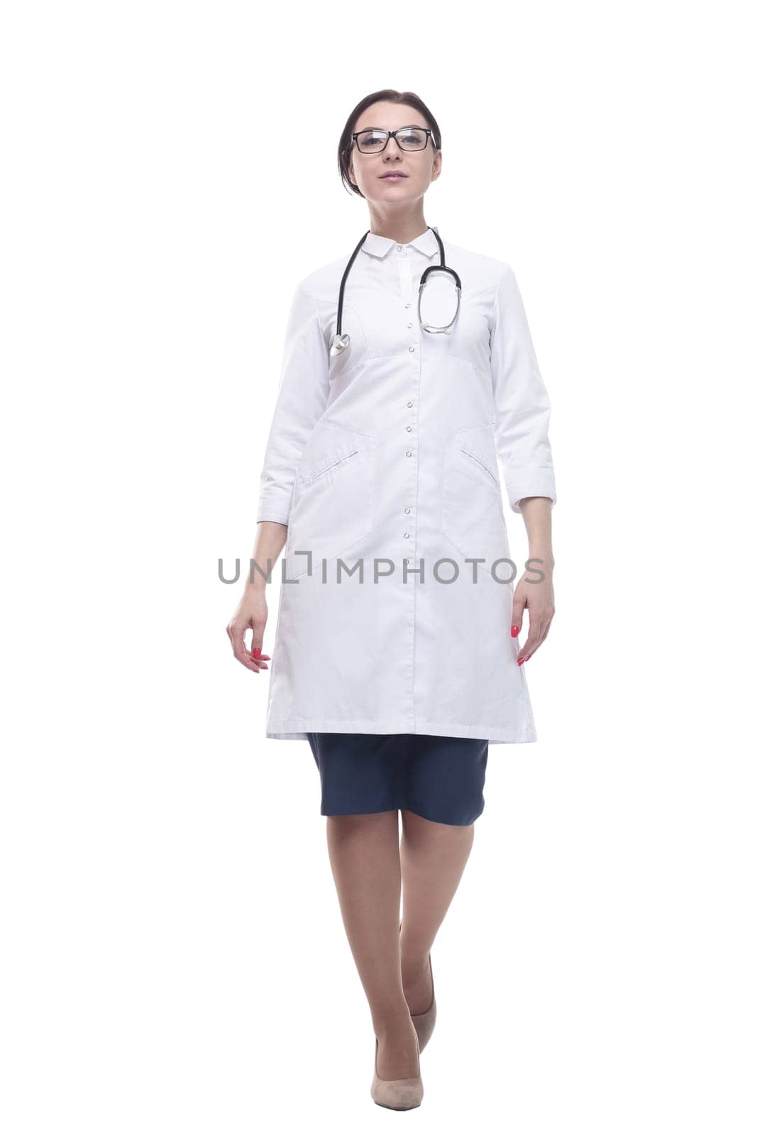 confident female doctor with a stethoscope striding forward. isolated on a white background.