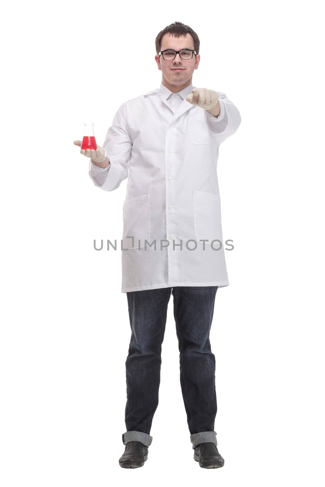 Cheerful male doctor in a white coat in gloves shows thumb up and holding the beaker