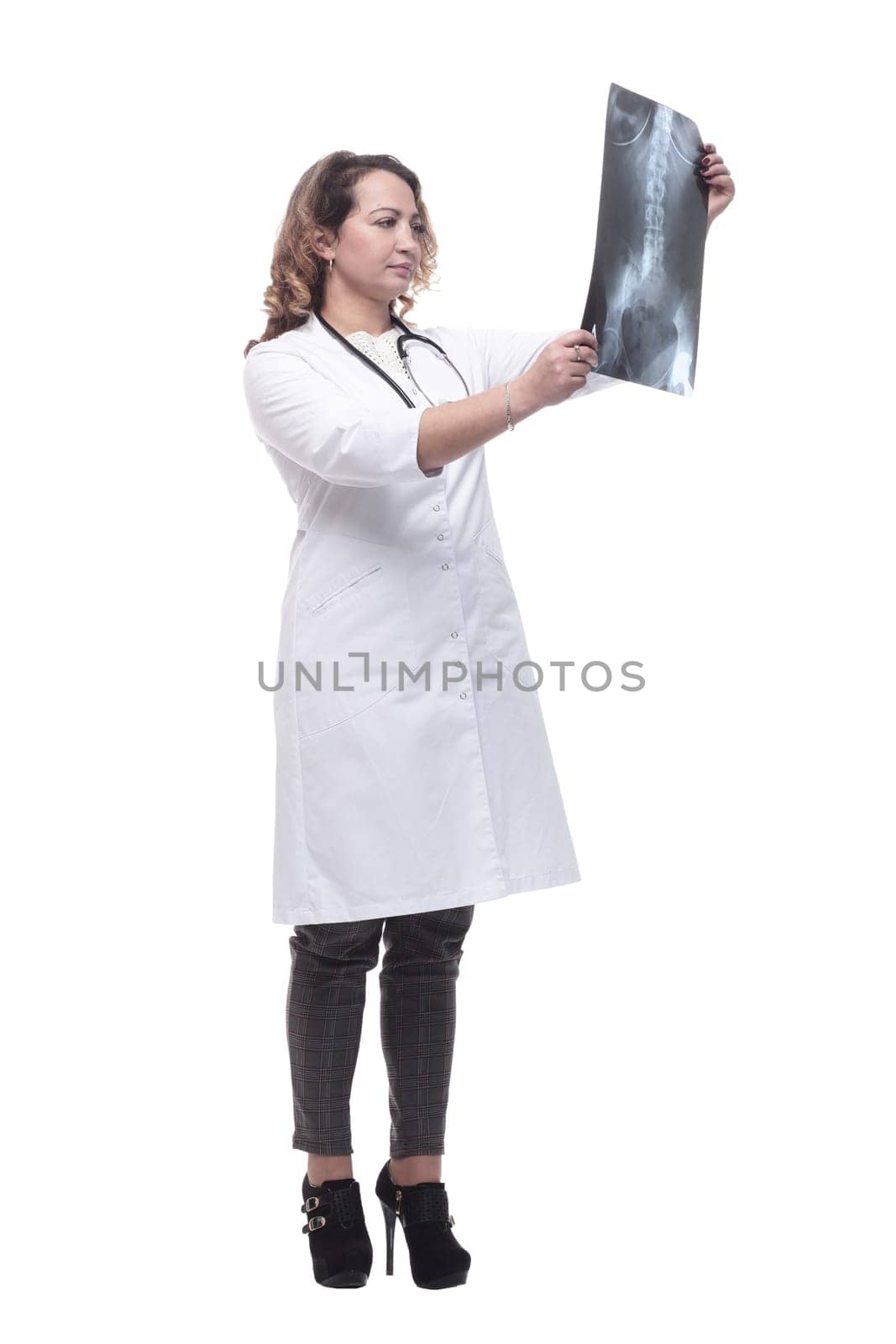 young female doctor looking at an x-ray. isolated on a white background.