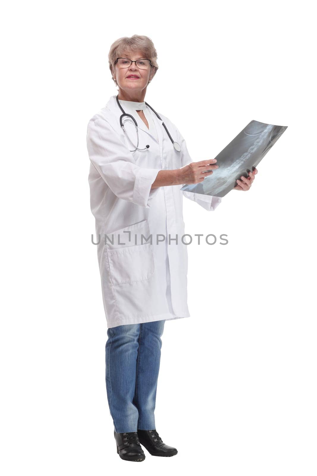 Front view of female doctor wearing stethoscope and glasses looking at an x-ray. Concept of medical help
