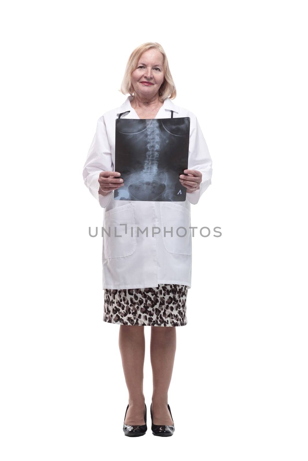 in full growth.female doctor looking at an x-ray. isolated on a white background.