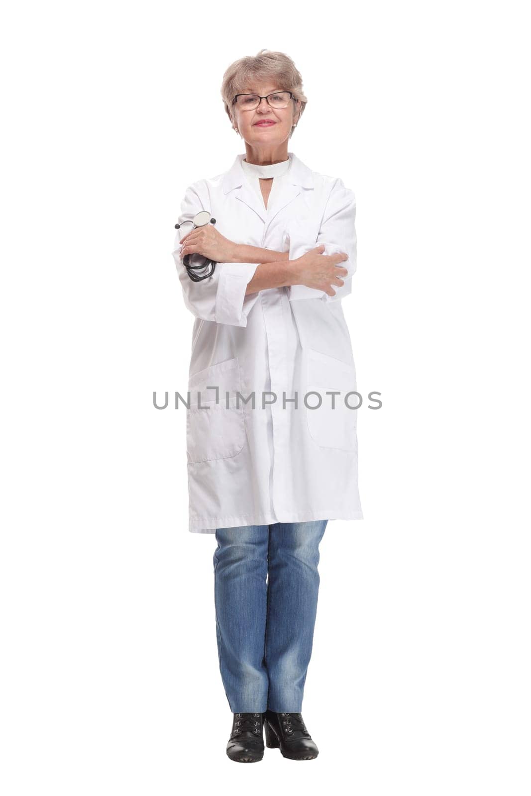 Studio shot of young happy woman doctor holding stethoscope and smiling while pointing finger up