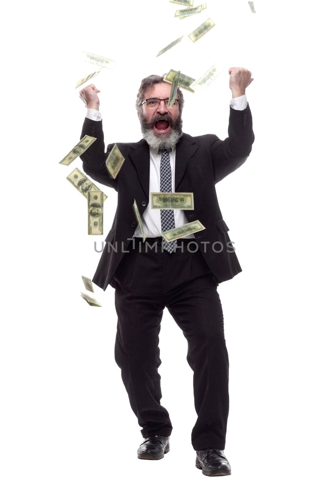 in full growth. happy businessman in the rain of banknotes. isolated on a white