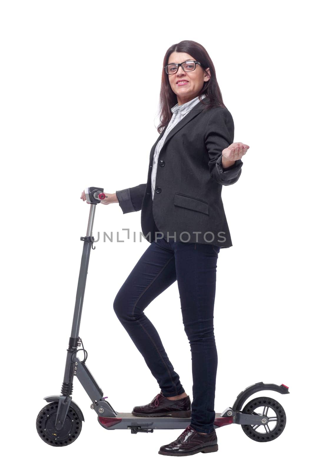 Full length portrait of a woman riding a scooter isolated on white background and pointede at camera