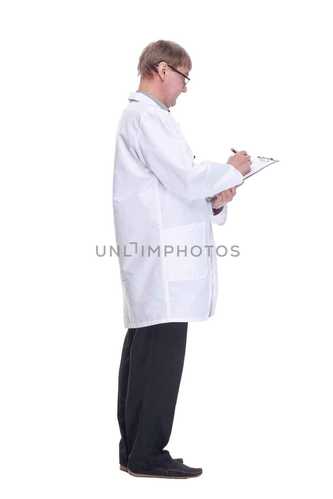 side view. attending doctor is writing recommendations in the clipboard. isolated on a white background.