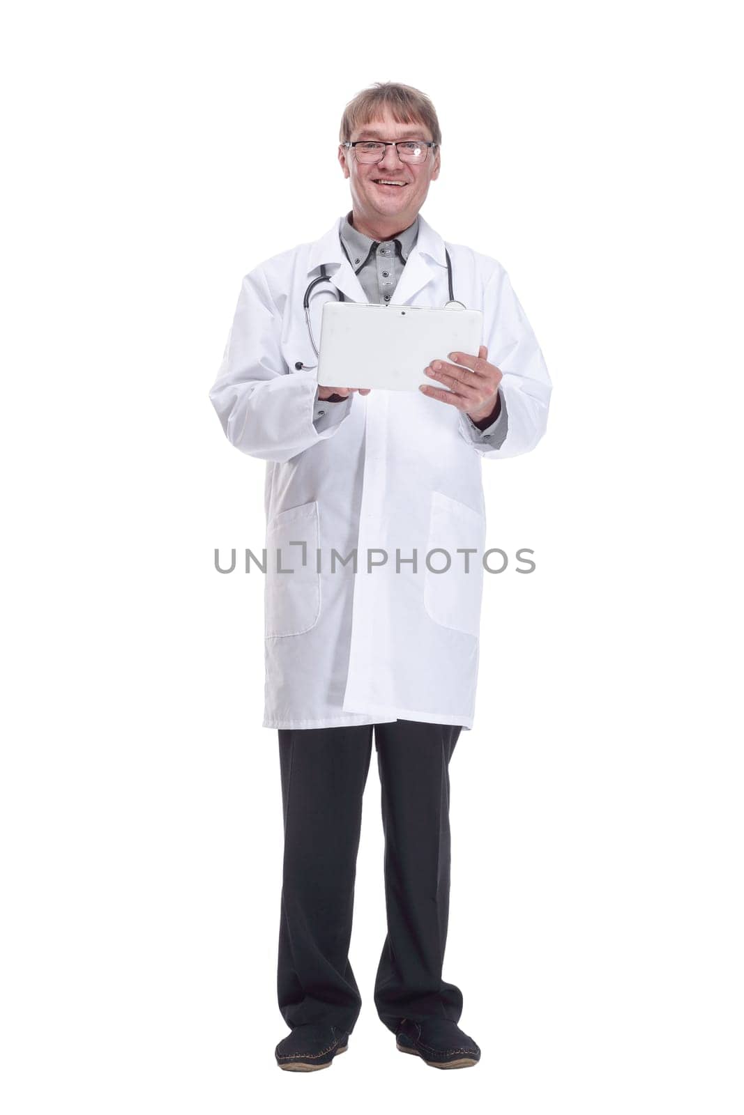 in full growth. smiling doctor with a digital tablet .isolated on a white background.