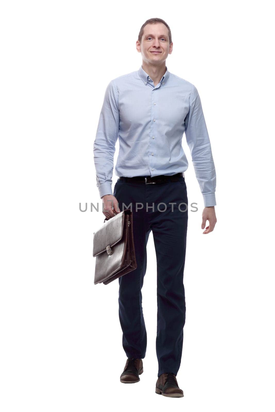 in full growth. a young man with a leather briefcase striding forward. isolated on a white