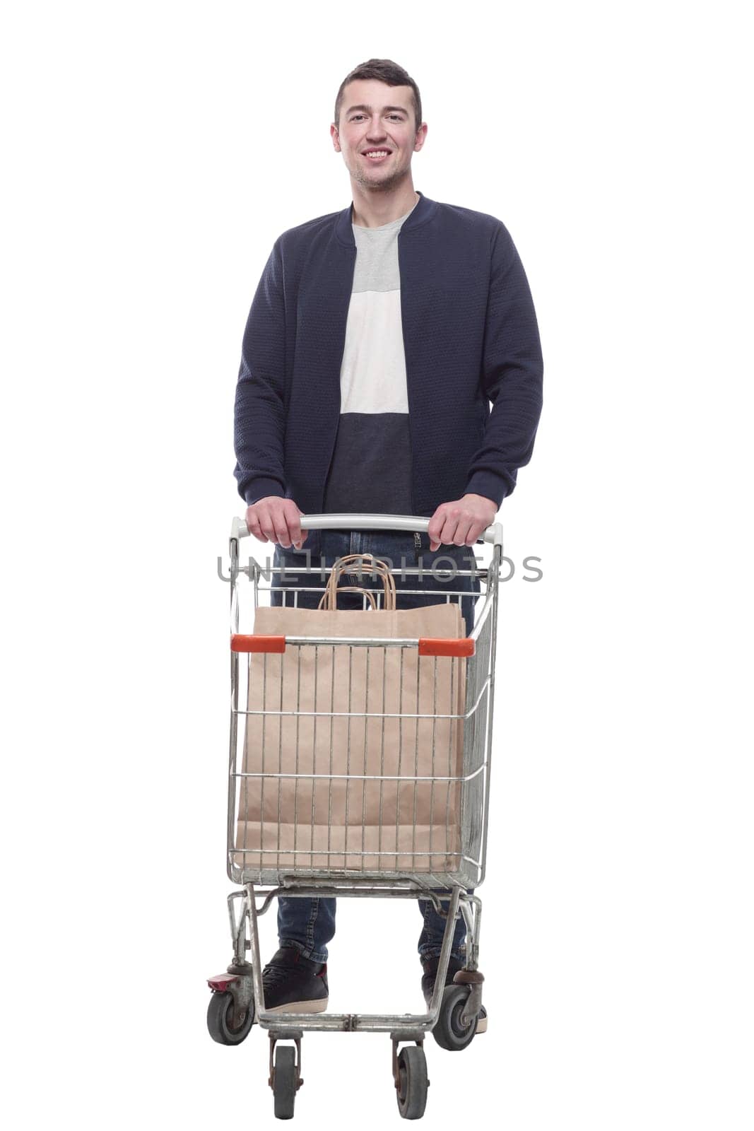 smiling young man with a shopping cart . isolated on a white background.