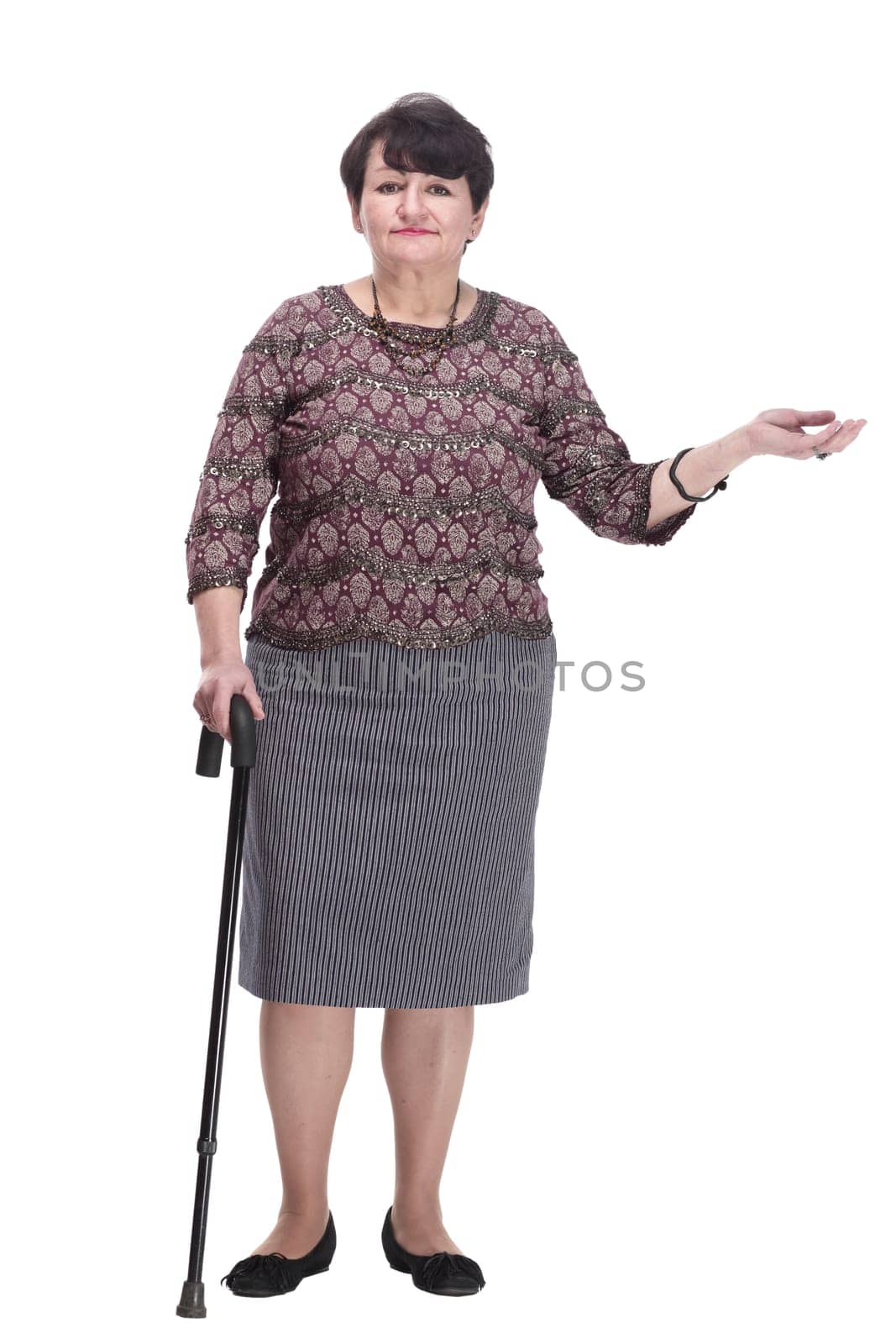 full-length. casual elderly woman with a walking stick. isolated on a white background.