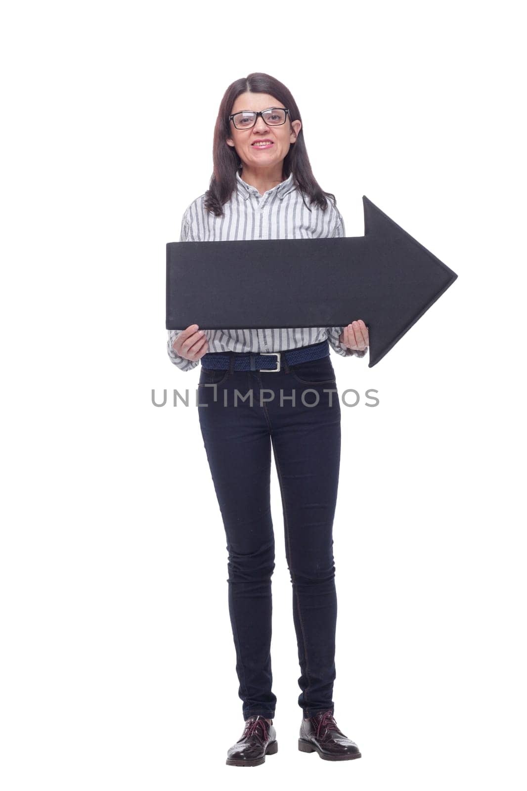 Beautiful business woman holding a black direction arrow sign, over a white background. Concept of the choice