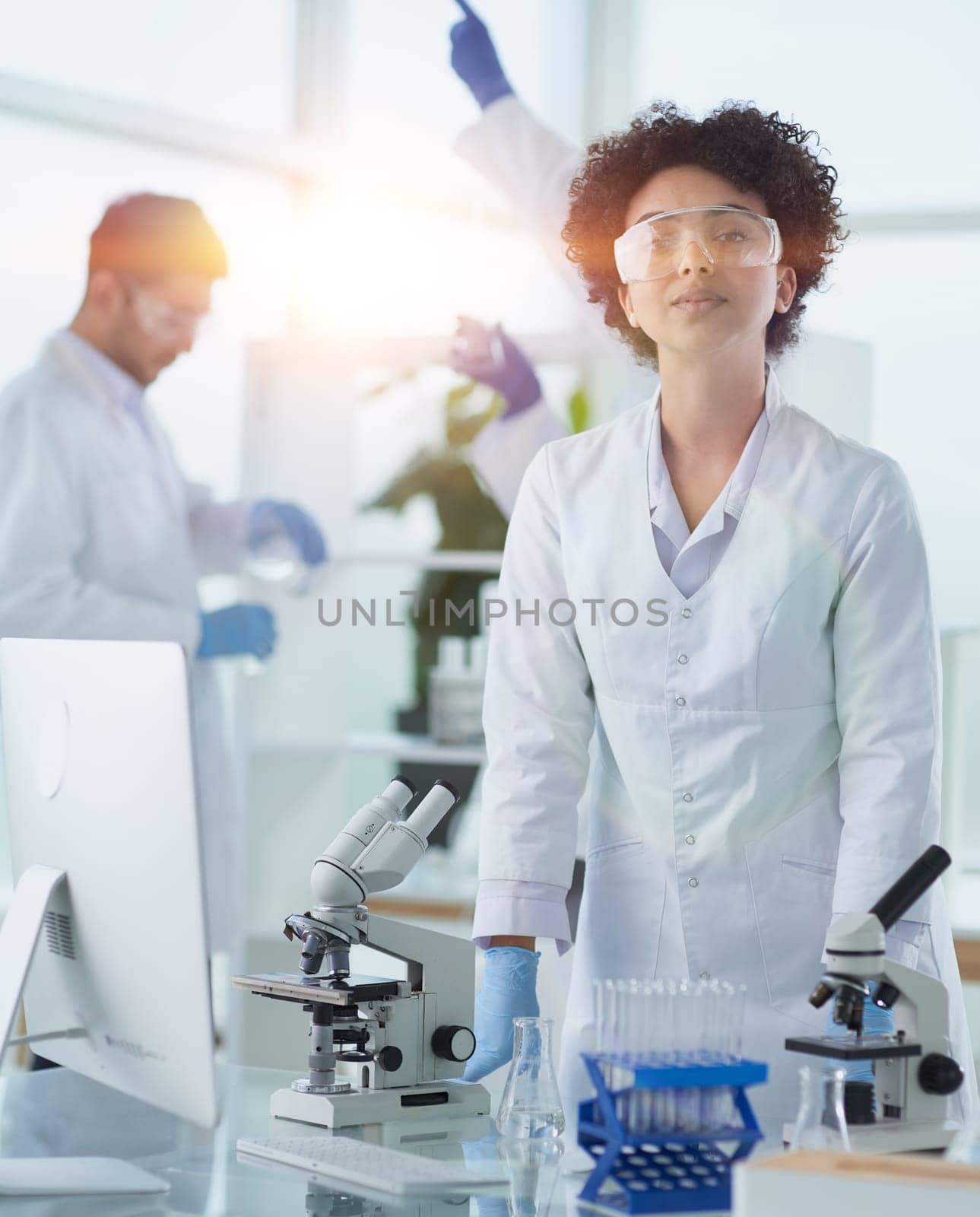 Smiling scientists looking at camera arms crossed in laboratory by asdf