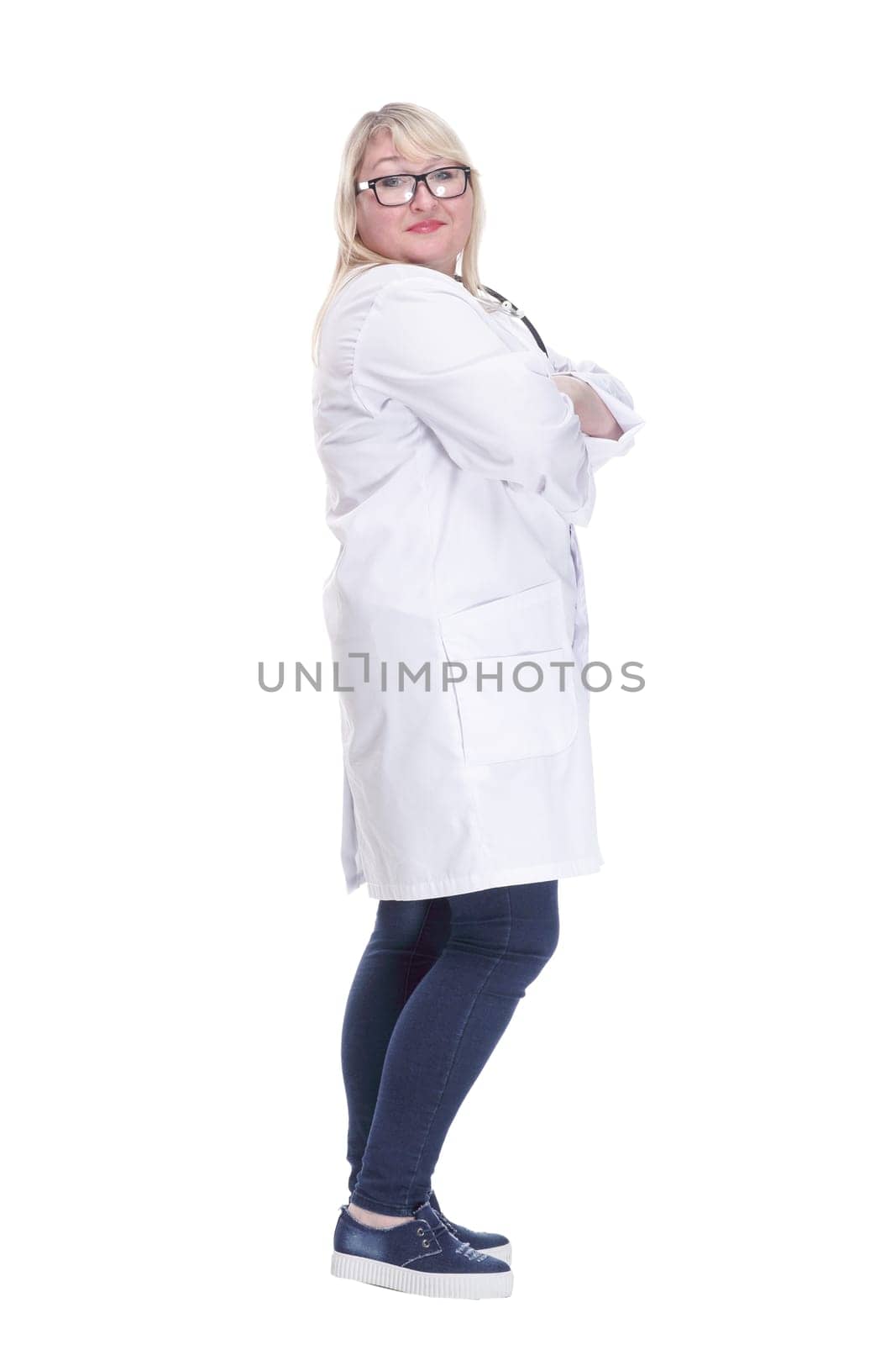 side view. Mature female doctor with a stethoscope looking at a white screen. isolated on a white background.