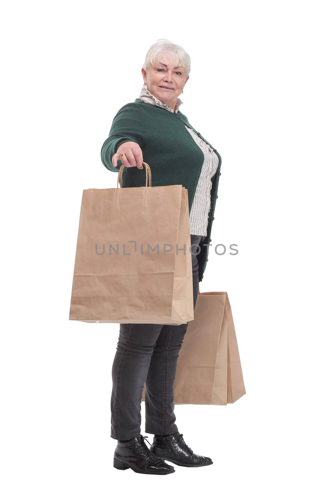 Smiling senior woman with shopping bags over white background. Sale and old people concept