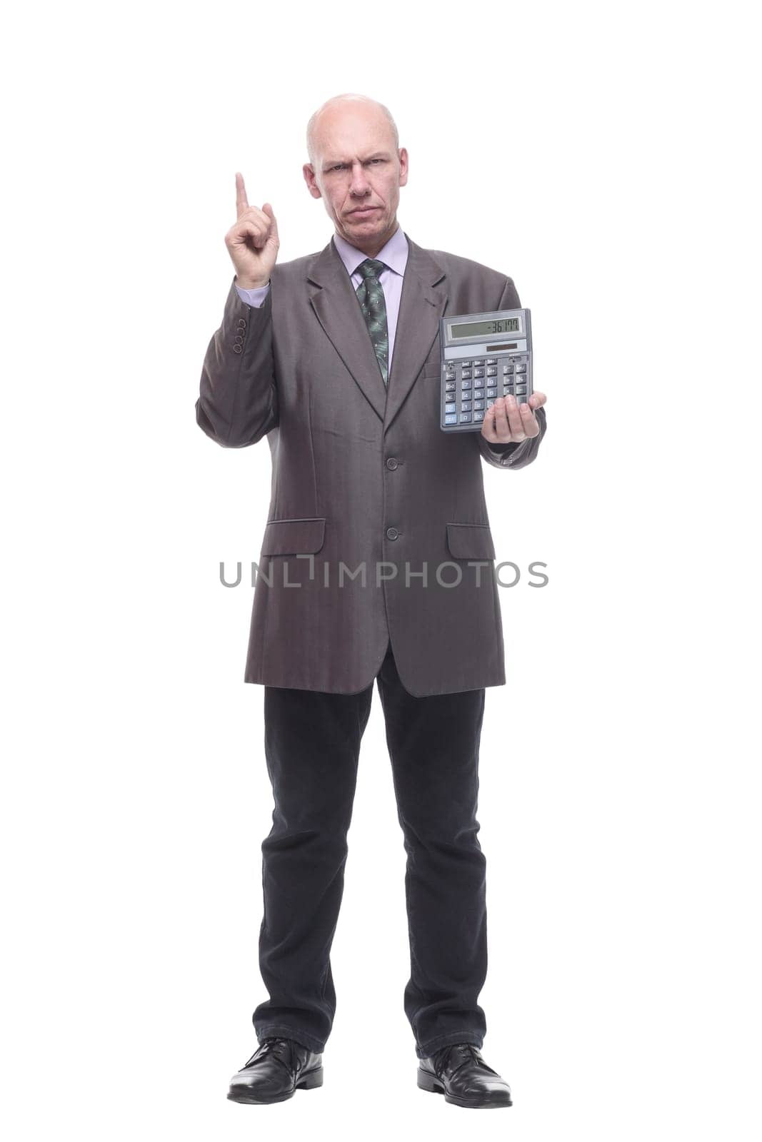 in full growth.business man with a calculator. isolated on a white background.