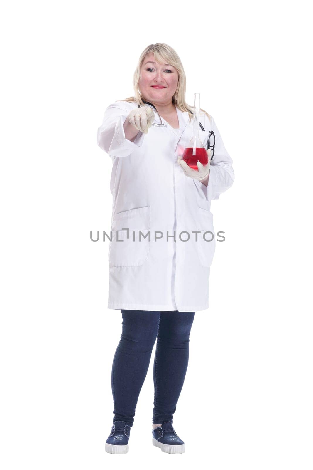 in full growth.smiling woman doctor with a laboratory flask . isolated on a white background.