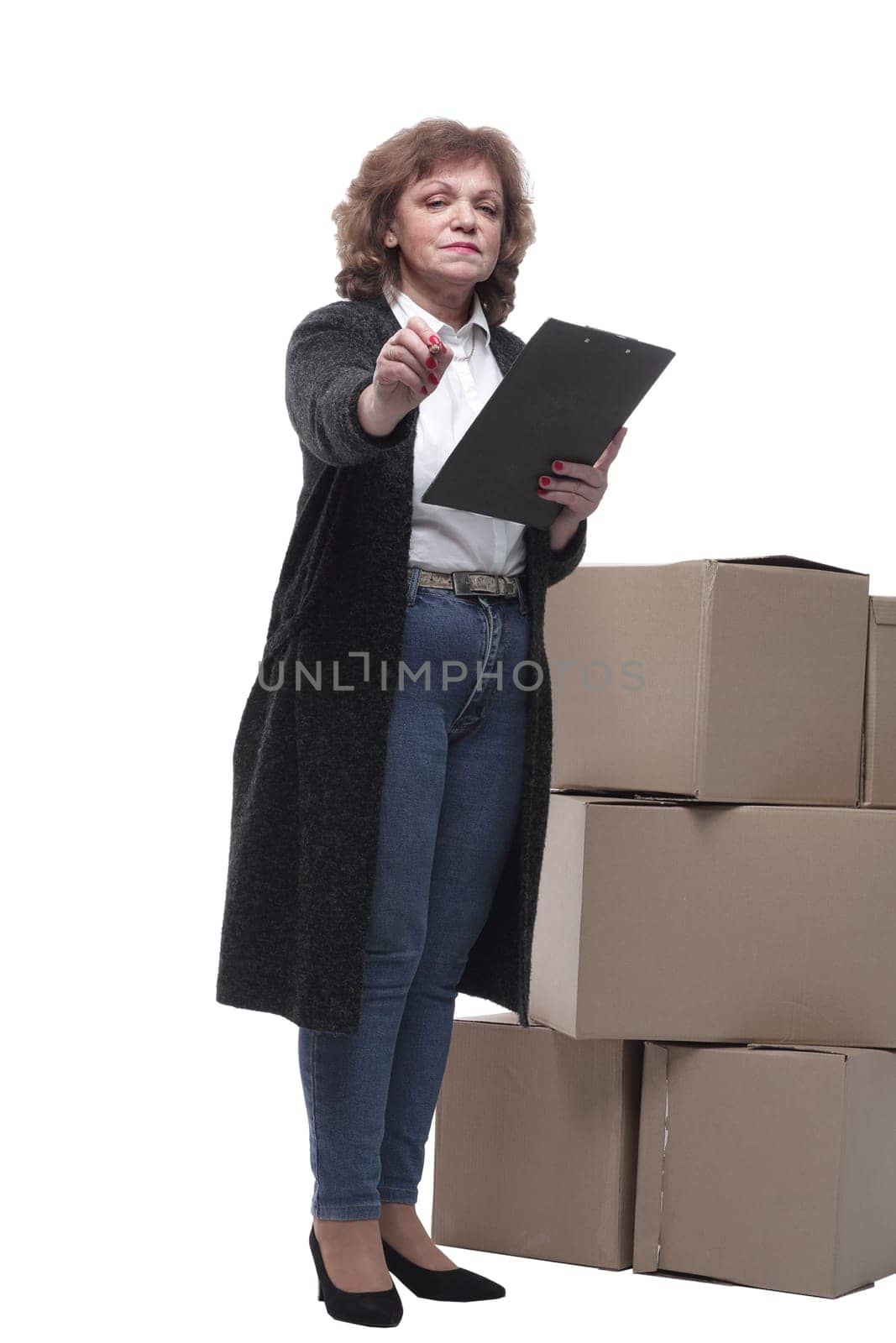 in full growth. serious woman signs documents after delivery. isolated on a white background