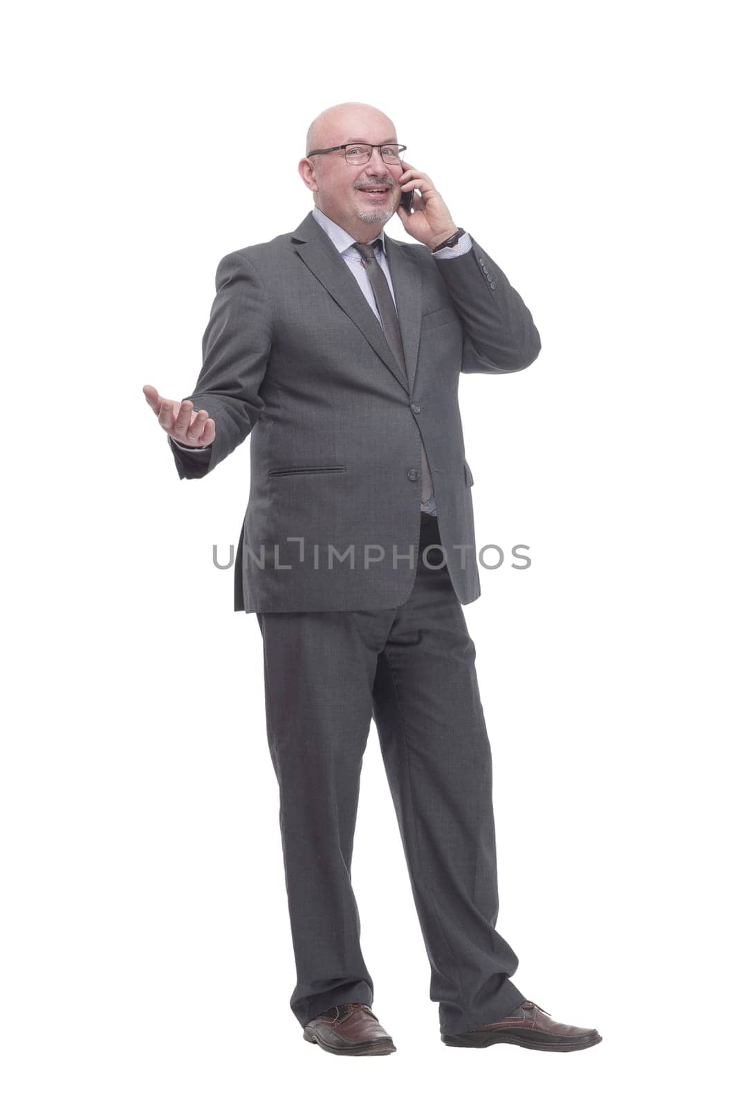 in full growth. business man with a smartphone.isolated on a white background.