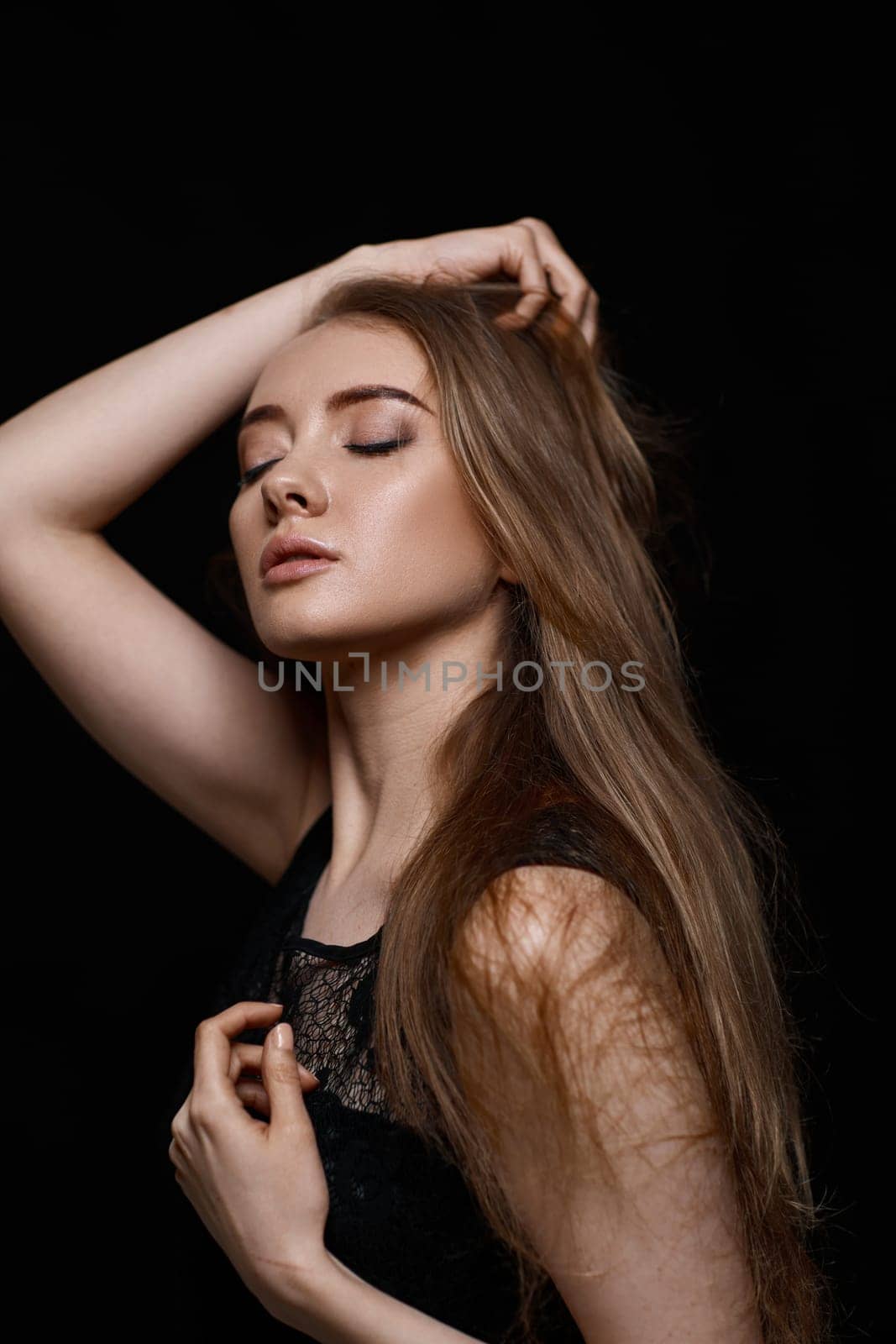 gorgeous brunette woman with long hair in black dress by erstudio