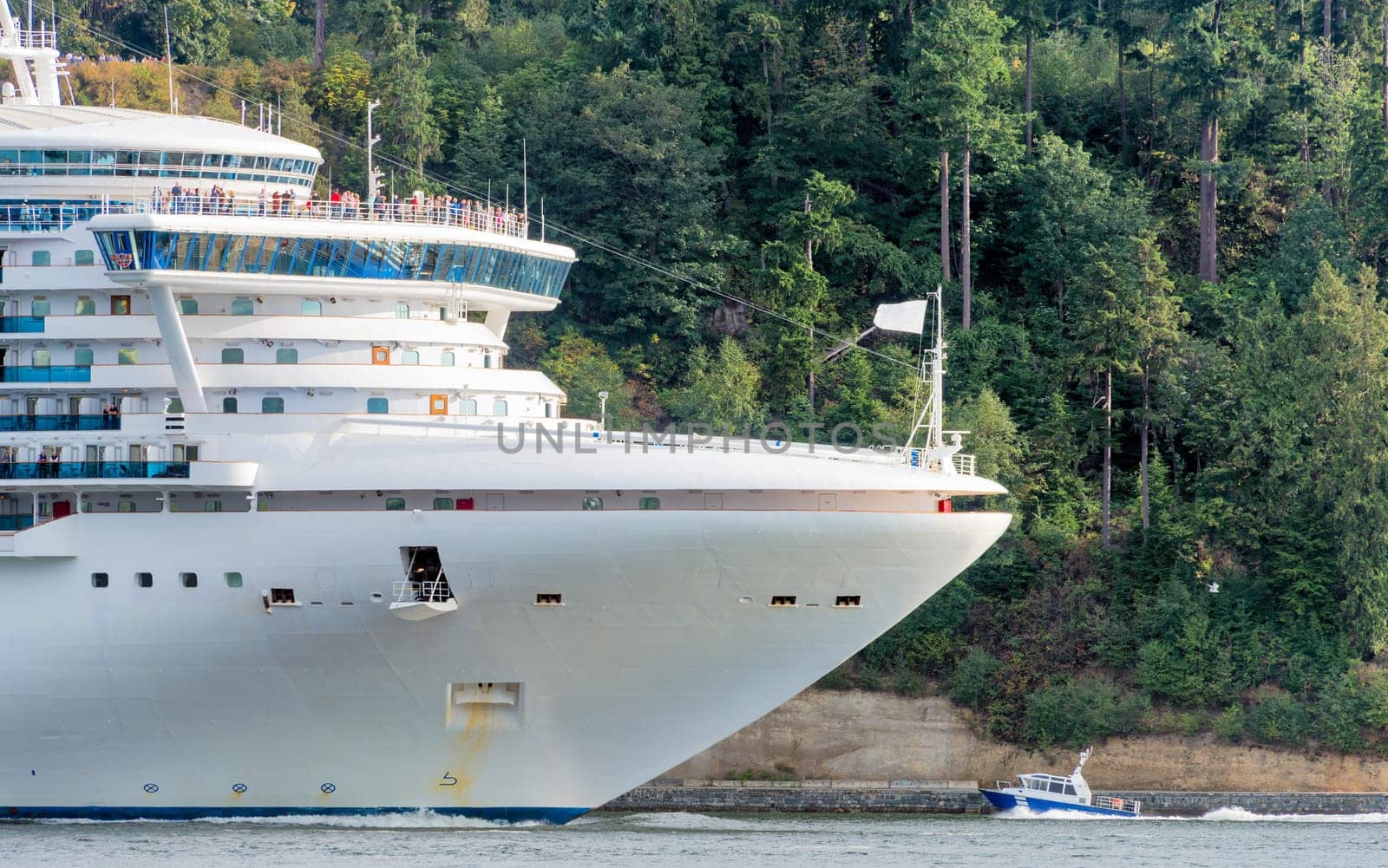 Huge white cruise liner passing by Stenley Park in Vancouver, Canada by Imagenet