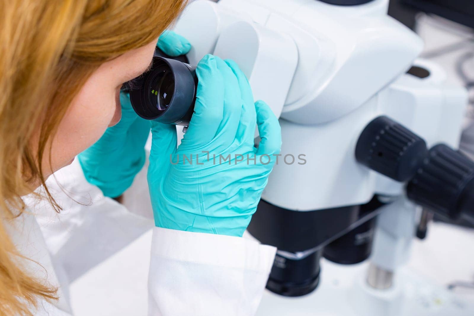 A scientist is utilizing a microscope, embodying the concepts of medical healthcare technology and pharmaceutical research and development.