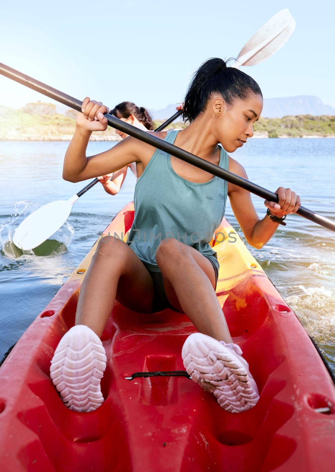 Lake, friends and kayak adventure with water sport on travel trip canoeing, kayaking and using paddle on calm nature river. Exercise, vacation or holiday with women enjoying boat activity in summer.