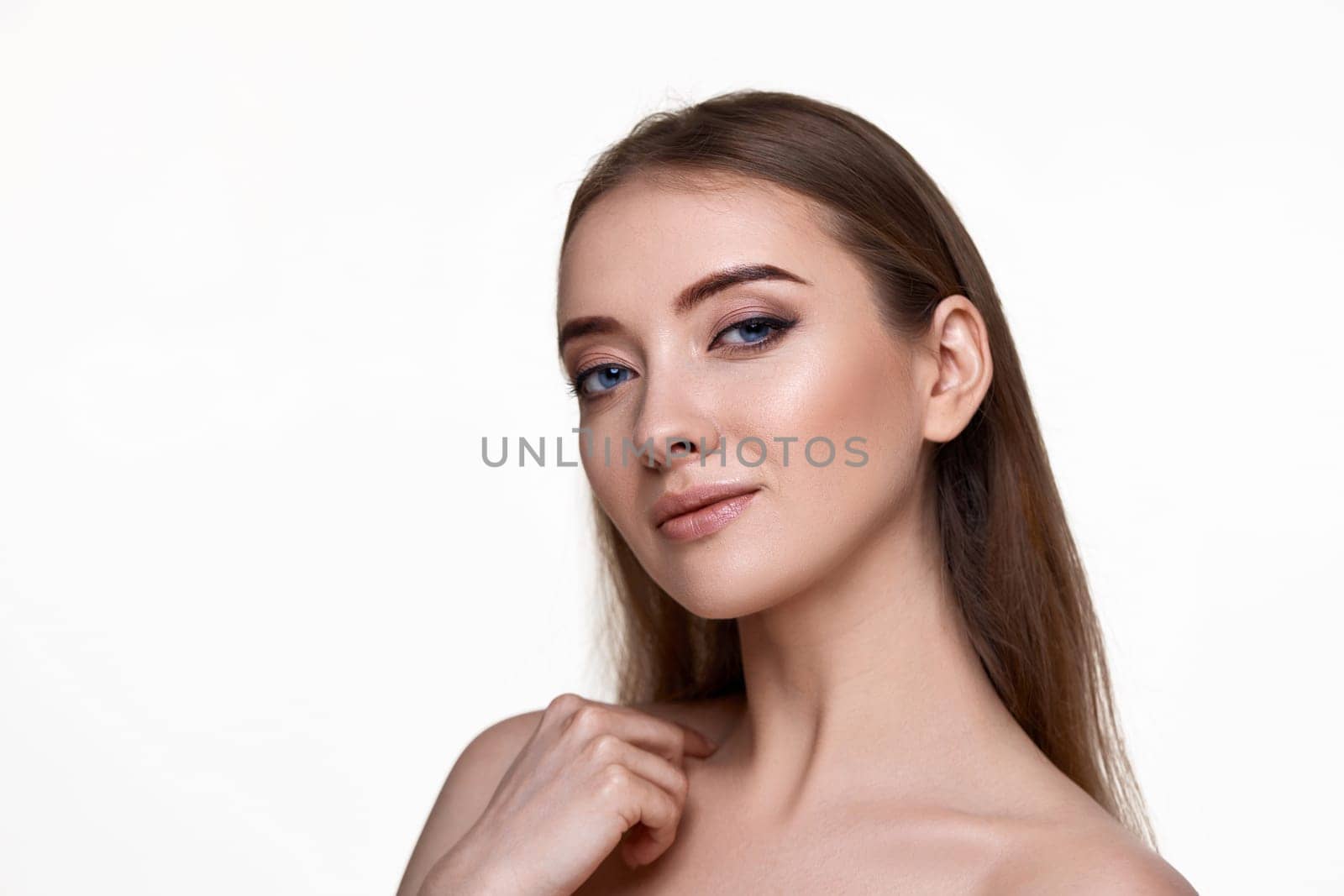 amazing young woman touching her shoulder and enjoying perfect soft clean skin on white background. copy space