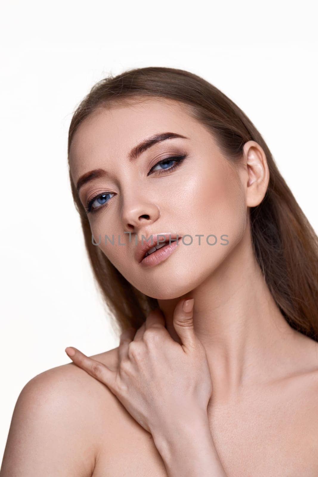 beautiful amazing young woman touching her shoulder and enjoying perfect soft clean skin on white background