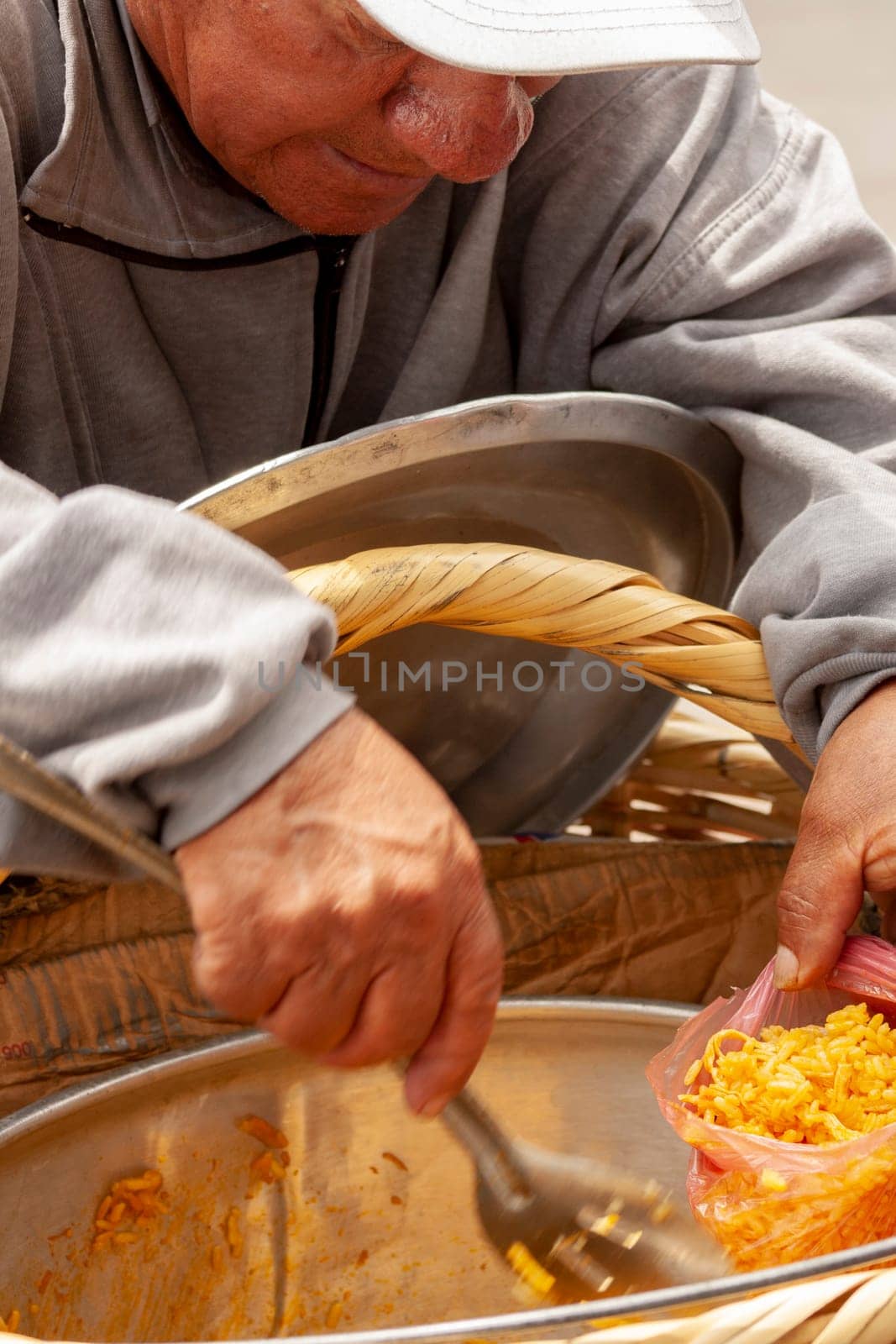 street vendor in white cap serving rice to a customer on the street. High quality photo