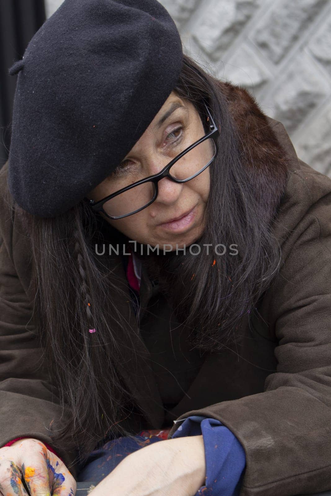 closeup of frustrated bohemian female painter abandoned in the street. High quality photo