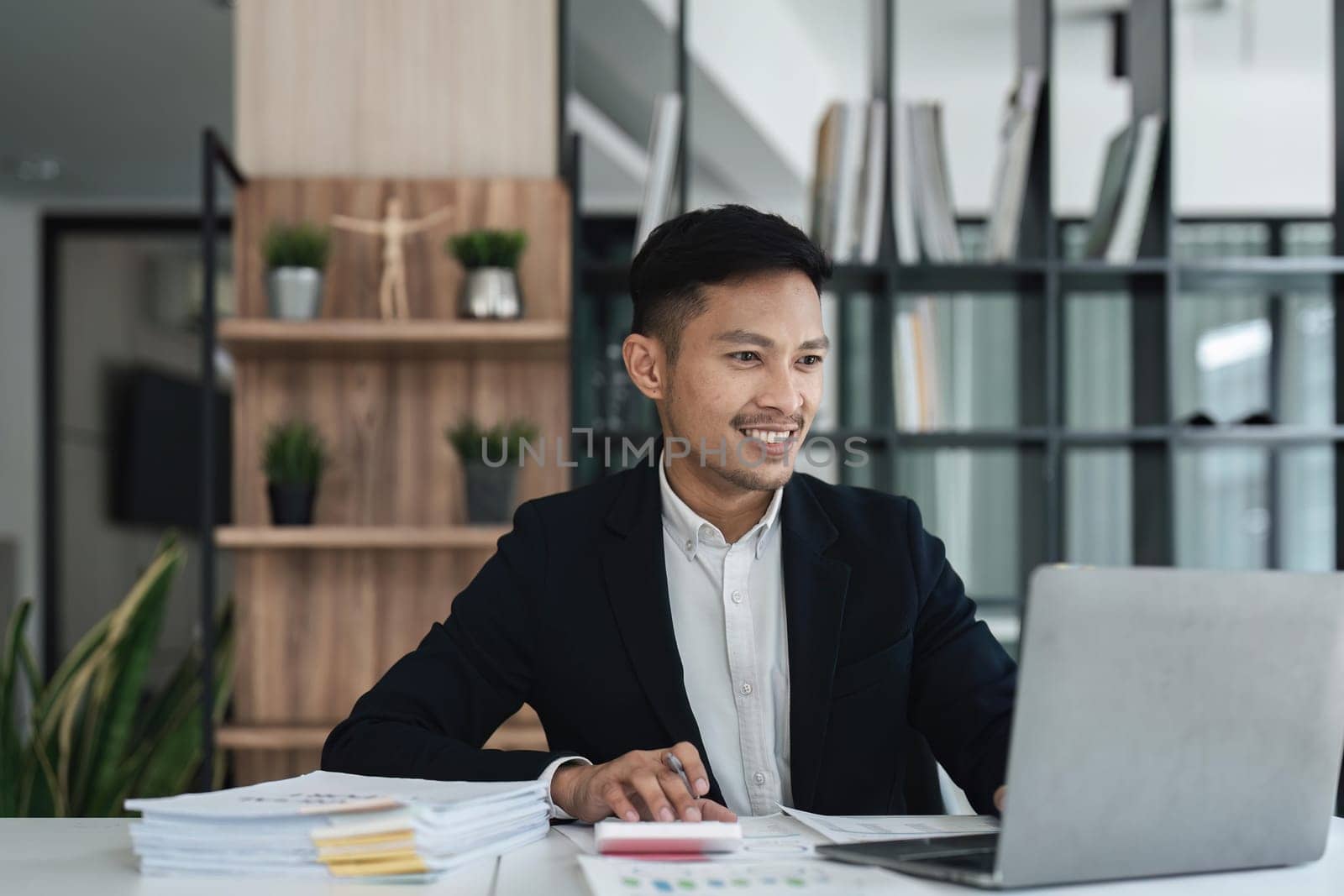 Businessman using laptop computer in office. Happy middle aged man, entrepreneur small business owner..