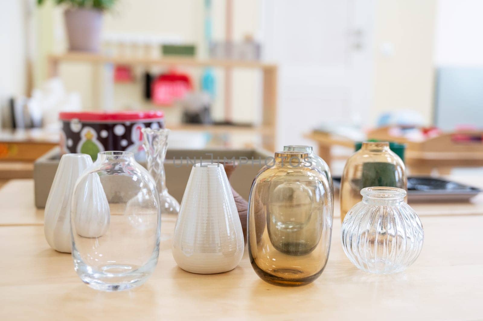 Classroom of Montessori kindergarten. Different glass Montessori items. Concept of children learning toy