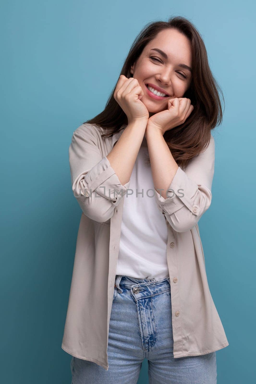 romantic charming brunette 30 year old female person dressed in a shirt and jeans on a studio background by TRMK